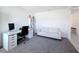 Bright home office space with a modern desk setup and a comfortable white sofa at 678 Fiddlesticks Dr, Davenport, FL 33837