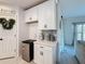 Kitchen area with white cabinetry, stainless steel mini-fridge, and pantry at 678 Fiddlesticks Dr, Davenport, FL 33837