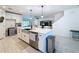 Bright kitchen boasts white cabinetry, stainless steel appliances, and a large central island with bar seating at 678 Fiddlesticks Dr, Davenport, FL 33837
