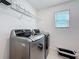 Laundry room with LG washer and dryer, overhead rack, and window at 678 Fiddlesticks Dr, Davenport, FL 33837