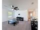 Spacious living room with a modern ceiling fan and a neutral color palette at 678 Fiddlesticks Dr, Davenport, FL 33837