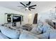Spacious living room features a sectional sofa, media center, and flows into the dining area at 678 Fiddlesticks Dr, Davenport, FL 33837