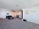 Expansive living room featuring a modern entertainment center and neutral decor at 678 Fiddlesticks Dr, Davenport, FL 33837