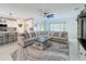 Cozy living room featuring a large sectional sofa, modern ceiling fan, and view into the kitchen at 678 Fiddlesticks Dr, Davenport, FL 33837