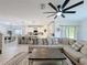 Open-concept living room flows into the kitchen and dining area, featuring a large sectional sofa at 678 Fiddlesticks Dr, Davenport, FL 33837