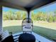 Inviting covered porch with comfortable chair and view of the backyard at 678 Fiddlesticks Dr, Davenport, FL 33837