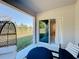 Cozy covered porch with comfortable furniture and view of the green backyard at 678 Fiddlesticks Dr, Davenport, FL 33837