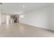 Open-concept living area with tile flooring and a view into the modern kitchen at 9097 Wildlight Trl, Wildwood, FL 34785
