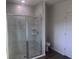 Bathroom showcasing a frameless glass shower with marble tile and built-in shelving at 121 S Cory Dr, Edgewater, FL 32141