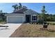 Charming single-Gathering home featuring a two-car garage and landscaped front yard on a sunny day at 121 S Cory Dr, Edgewater, FL 32141