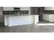 Modern kitchen featuring stainless steel appliances, a large island with granite countertops and white cabinetry at 121 S Cory Dr, Edgewater, FL 32141