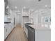 Modern kitchen with farmhouse sink, stainless steel appliances, and white cabinets at 15086 Summer Harvest St, Winter Garden, FL 34787