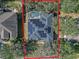 Aerial view showing a house with solar panels and a pool in a wooded area at 3954 Old Dunn Rd, Apopka, FL 32712