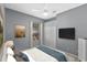 Bright bedroom with a queen-size bed, a TV, and ample closet space at 3954 Old Dunn Rd, Apopka, FL 32712