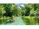 People floating down a calm river in inner tubes at 3954 Old Dunn Rd, Apopka, FL 32712