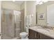 Well-lit bathroom features a walk-in shower with glass doors and a granite vanity with ample storage at 471 Lasso Dr, Kissimmee, FL 34747
