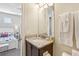 Well-maintained bathroom with granite vanity top, dark wood cabinetry, and an adjacent bedroom at 471 Lasso Dr, Kissimmee, FL 34747