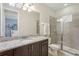 Bathroom featuring a glass shower, granite countertop, dark cabinets, and toilet at 471 Lasso Dr, Kissimmee, FL 34747