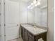 Bathroom with a granite countertop, undermount sink, and dark cabinets at 471 Lasso Dr, Kissimmee, FL 34747