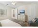 Inviting bedroom with calming colors, showcases a modern dresser, with decorative accents and a comfy chair at 471 Lasso Dr, Kissimmee, FL 34747