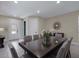 Well-lit dining room with a large table, seating for eight, and neutral color scheme at 471 Lasso Dr, Kissimmee, FL 34747