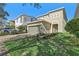 Charming two-story home with well-manicured landscaping, a two-car garage, and a paved driveway at 471 Lasso Dr, Kissimmee, FL 34747