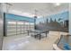 Spacious garage with painted walls and lighting with fun mural and ping pong table at 471 Lasso Dr, Kissimmee, FL 34747