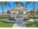 Charming white gazebo surrounded by lush landscaping, perfect for relaxing and enjoying the outdoors at 471 Lasso Dr, Kissimmee, FL 34747