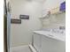 Functional laundry room with modern appliances, shelving, and decor at 471 Lasso Dr, Kissimmee, FL 34747