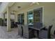 Covered patio with a dining table perfect for outdoor dining and relaxation with a view of the backyard at 471 Lasso Dr, Kissimmee, FL 34747