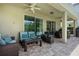 Inviting covered patio with comfortable seating, ceiling fan, and seamless access to the backyard pool area at 471 Lasso Dr, Kissimmee, FL 34747