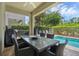 An outdoor patio area offers a shaded dining space adjacent to a sparkling private swimming pool at 471 Lasso Dr, Kissimmee, FL 34747