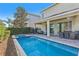 Backyard featuring a private pool, patio with furniture, and well-manicured landscaping at 471 Lasso Dr, Kissimmee, FL 34747