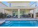Backyard featuring a private pool, covered patio with furniture, and privacy fence at 471 Lasso Dr, Kissimmee, FL 34747