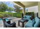 Relaxing outdoor patio area with a jacuzzi, comfortable seating, and lush greenery at 471 Lasso Dr, Kissimmee, FL 34747