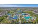 Expansive community water park with pools, slides, and recreational facilities amidst lush landscaping and sunny skies at 471 Lasso Dr, Kissimmee, FL 34747