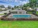 Community pool with a fenced area and a clubhouse providing a relaxing atmosphere at 7707 Country Pl, Winter Park, FL 32792