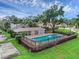 Relaxing community pool with an outdoor clubhouse, surrounded by lush greenery at 7707 Country Pl, Winter Park, FL 32792