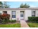 Charming townhome exterior with well-maintained landscaping and inviting front entrance at 7707 Country Pl, Winter Park, FL 32792