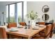 Elegant dining room features a wooden table with seating for six with bright natural lighting at 2661 Via Tuscany, Winter Park, FL 32789