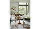 Well-lit open living room with modern furnishings, striking art, and large windows offering a bright and welcoming space at 2661 Via Tuscany, Winter Park, FL 32789