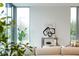 Comfortable living space features a neutral sofa, large windows, and a stylish accent wall with an abstract art piece at 2661 Via Tuscany, Winter Park, FL 32789