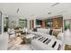 Bright living room featuring modern decor, a comfortable sectional sofa, and seamless flow to the kitchen at 2661 Via Tuscany, Winter Park, FL 32789