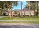 Stunning two-story home showcasing curb appeal and mature landscaping at 2781 Tree Meadow Loop, Apopka, FL 32712