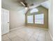 Bright bedroom featuring vaulted ceiling, tiled floors, ceiling fan, and large windows for ample natural light at 375 Lake Ontario Ct # 102, Altamonte Springs, FL 32701