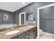 Elegant bathroom with double vanity, granite countertop, and a soaking tub at 2891 Upper Park Rd, Orlando, FL 32814