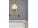 Relaxing bathroom with an oval soaking tub and ornate mirror at 2891 Upper Park Rd, Orlando, FL 32814