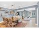 Open concept dining room with a large wooden table, and views into the living room at 2891 Upper Park Rd, Orlando, FL 32814