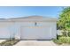 Attached garage with white door and lantern at 2891 Upper Park Rd, Orlando, FL 32814