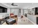 Spacious living room with comfortable seating, a large TV, and access to the kitchen at 2891 Upper Park Rd, Orlando, FL 32814